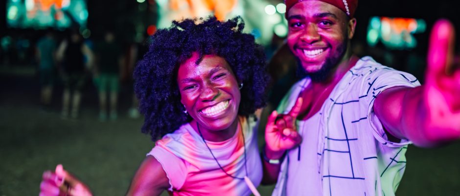 Two people leaving a nightclub in Accra, Ghana, smiling after a night ou