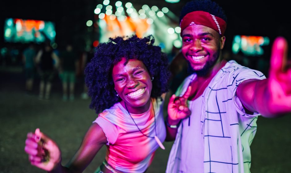 Two people leaving a nightclub in Accra, Ghana, smiling after a night ou