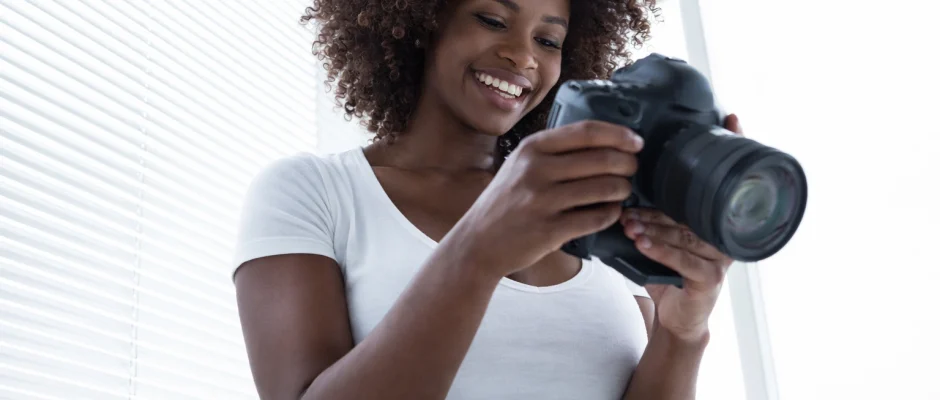 Man reviewing photos on a camera in Accra representing hobbies and social clubs in Accra Ghana