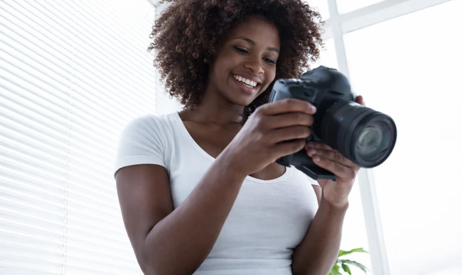 Man reviewing photos on a camera in Accra representing hobbies and social clubs in Accra Ghana