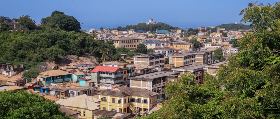 Panoramic view of Cape Coast Ghana downtown houses surrounded by green trees