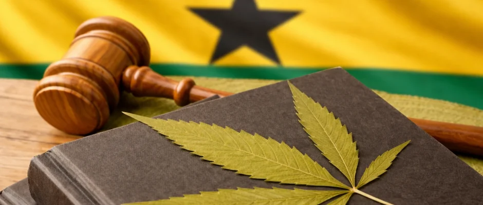 Cannabis leaf on law books with gavel and Ghana flag background