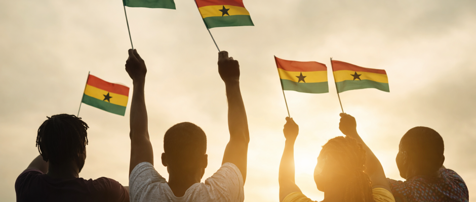 Black people holding Ghana flags during a celebration of Ghanaian heritage and diaspora connection