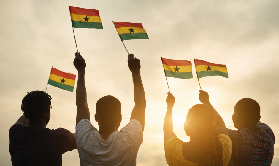 Black people holding Ghana flags during a celebration of Ghanaian heritage and diaspora connection