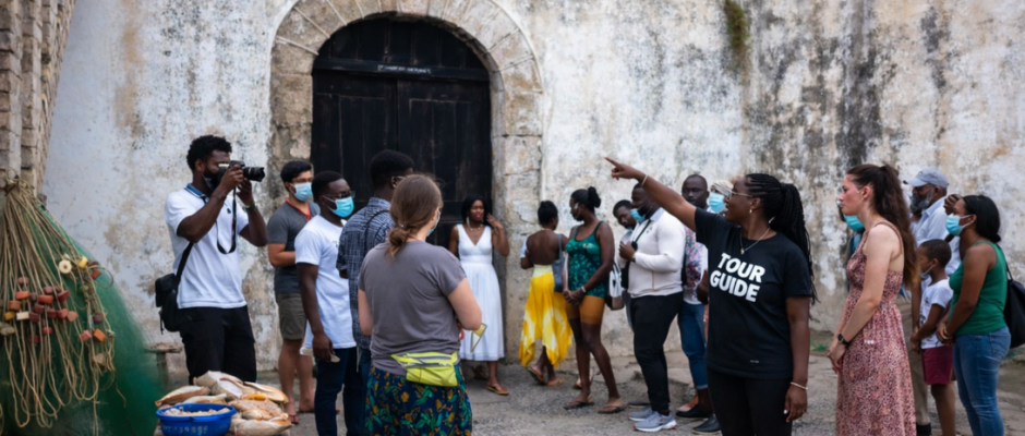 African American diaspora members visiting Ghana’s historic slave castles on the Atlantic coast, reflecting on ancestral connections to West Africa.