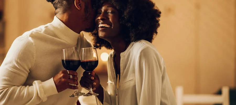 Best date spots in Ghana romantic couple enjoying dinner with wine during an intimate evening date