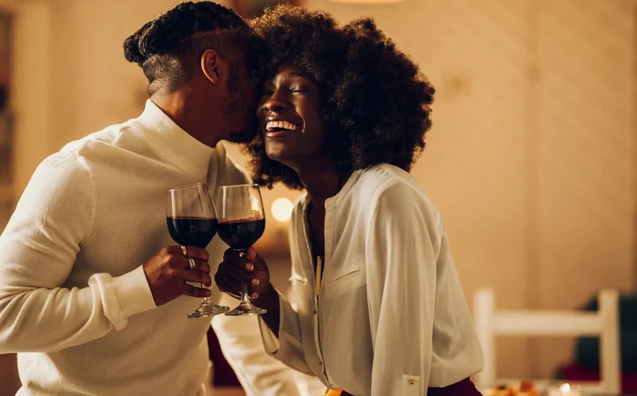 Best date spots in Ghana romantic couple enjoying dinner with wine during an intimate evening date