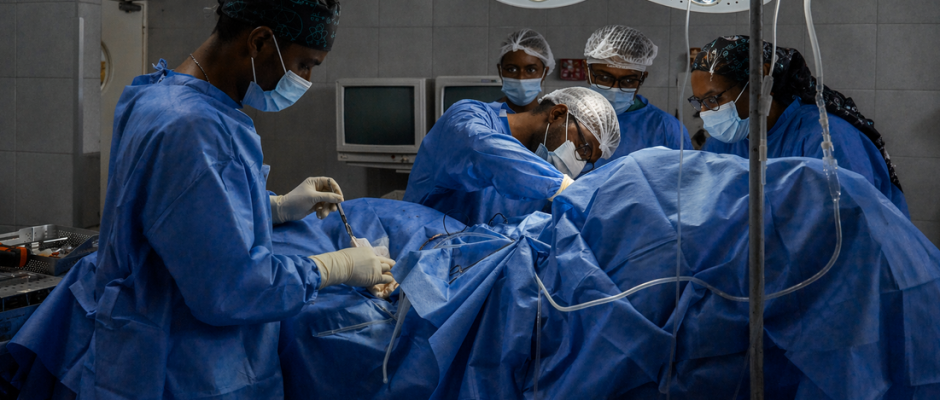 Cardiologists in Ghana performing a heart procedure in an operating room