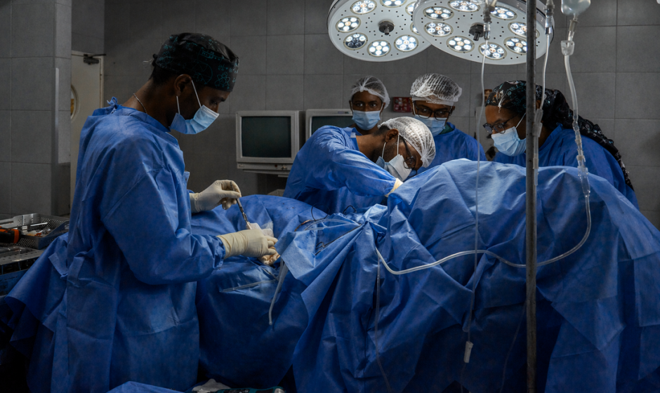 Cardiologists in Ghana performing a heart procedure in an operating room