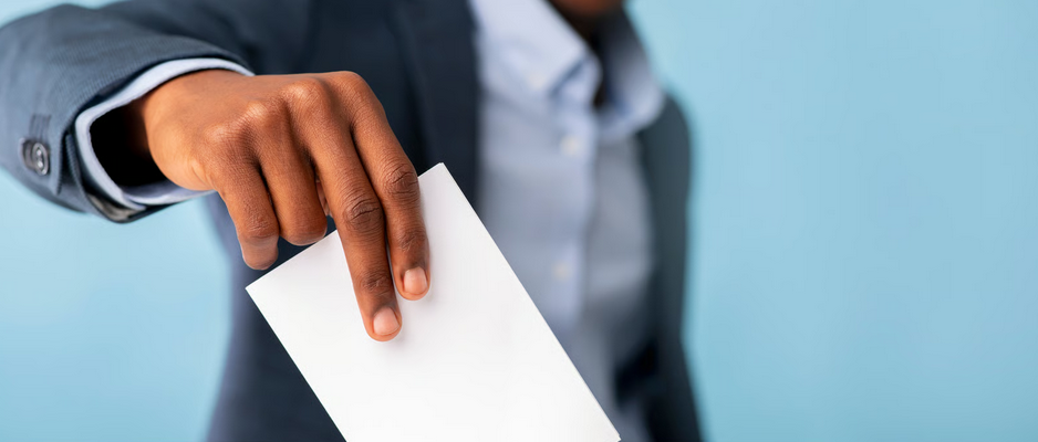 Ghana elections guide showing a voter placing a ballot into a ballot box during an election