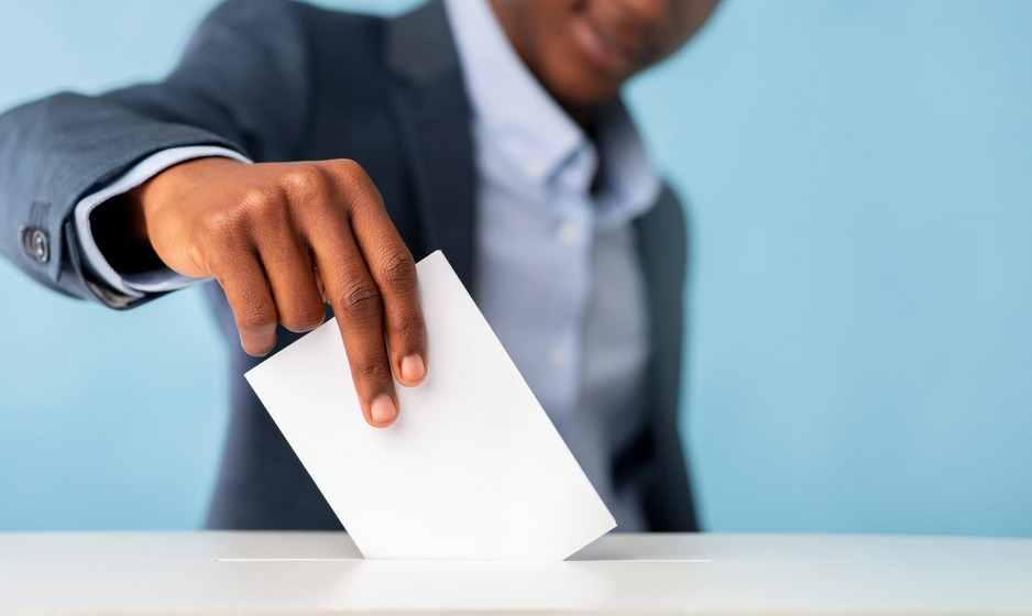 Ghana elections guide showing a voter placing a ballot into a ballot box during an election