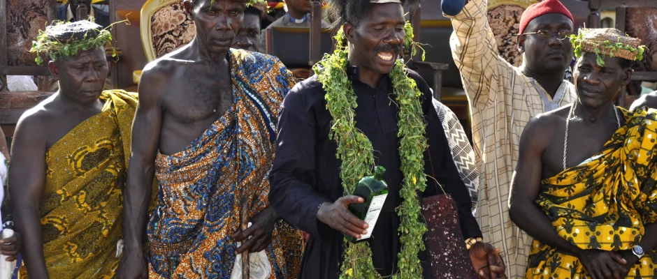 Traditional festival ceremony in Ghana with priest and community members in ceremonial clothing