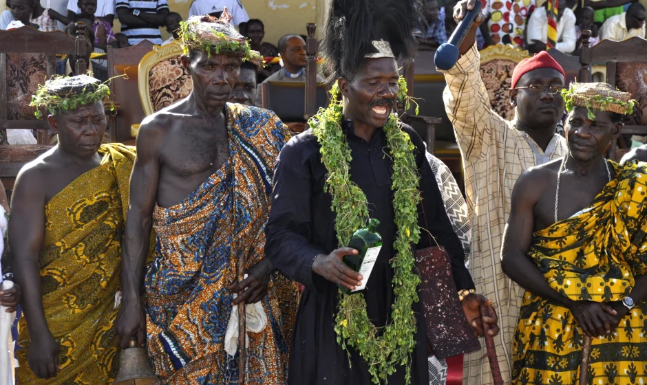 Traditional festival ceremony in Ghana with priest and community members in ceremonial clothing