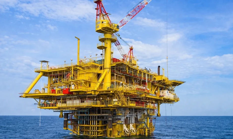 Jubilee offshore field oil rig in Ghana waters at sunset with illuminated platform and ocean view