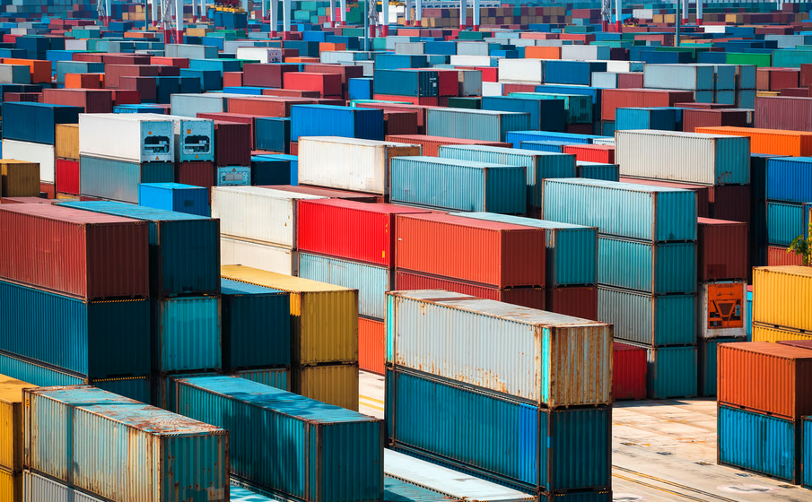 Shipping containers stacked at a busy cargo port, illustrating Ghana spare parts import duties and customs clearance delays.
