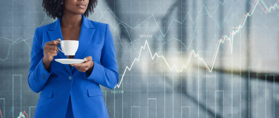 Professional Black Ghanaian woman in a blue business suit holding coffee with financial data charts representing AI investment growth in Ghana
