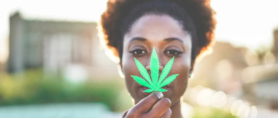 Woman holding cannabis leaf for Ghana cannabis regulatory programme article