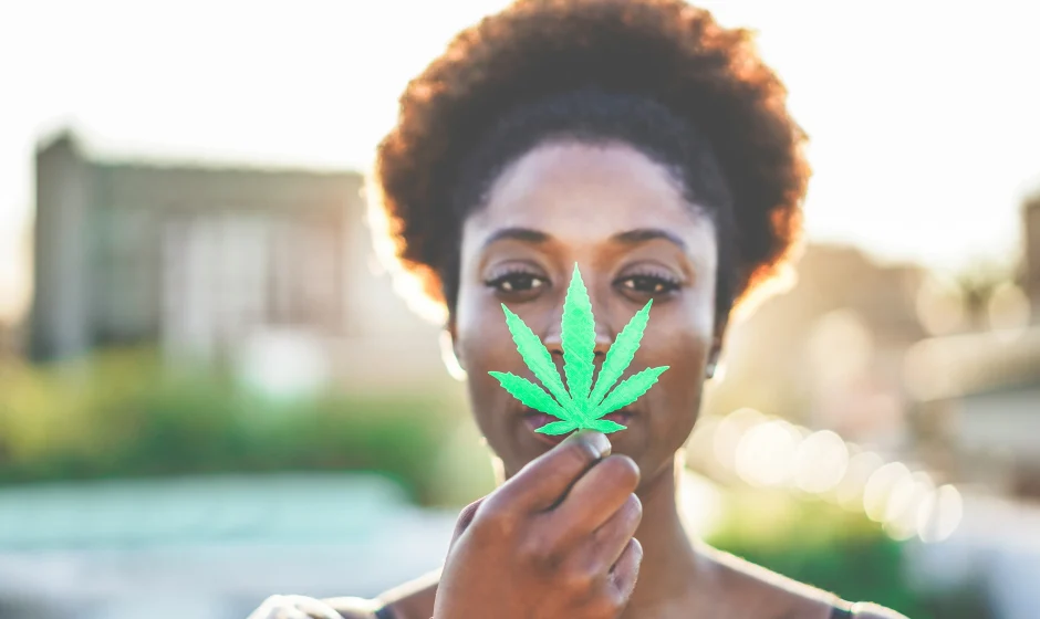 Woman holding cannabis leaf for Ghana cannabis regulatory programme article
