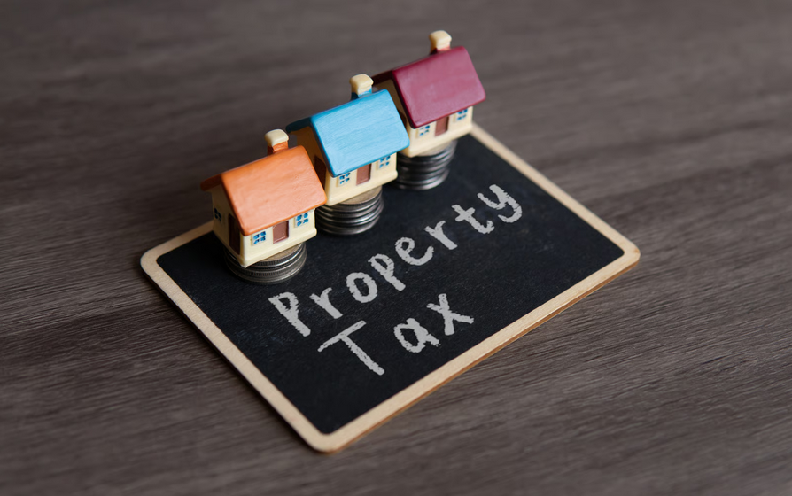 Property taxes in Ghana concept with model houses and tax sign for 2026 guide