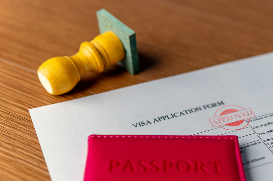 Ghana tourist visa application form with approved stamp and passport on desk