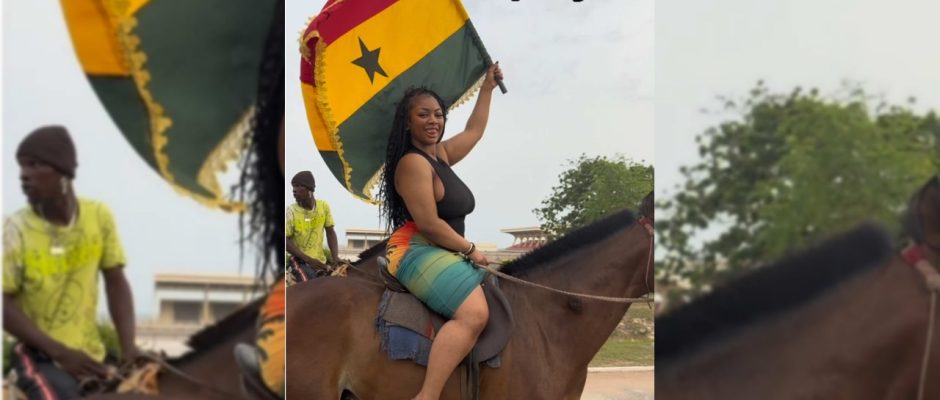 @gigiknowsbest1 riding a horse while holding a Ghana flag near the Black Star Gate