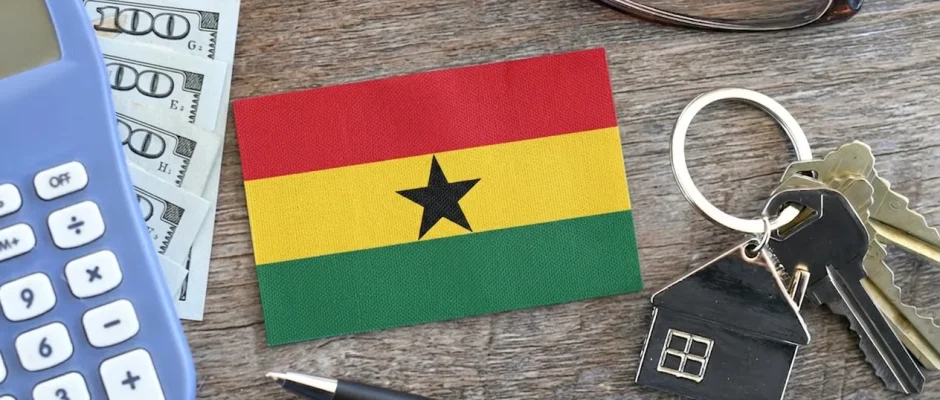 Ghana flag with house keys, calculator and US dollar bills representing the dollar rent ban