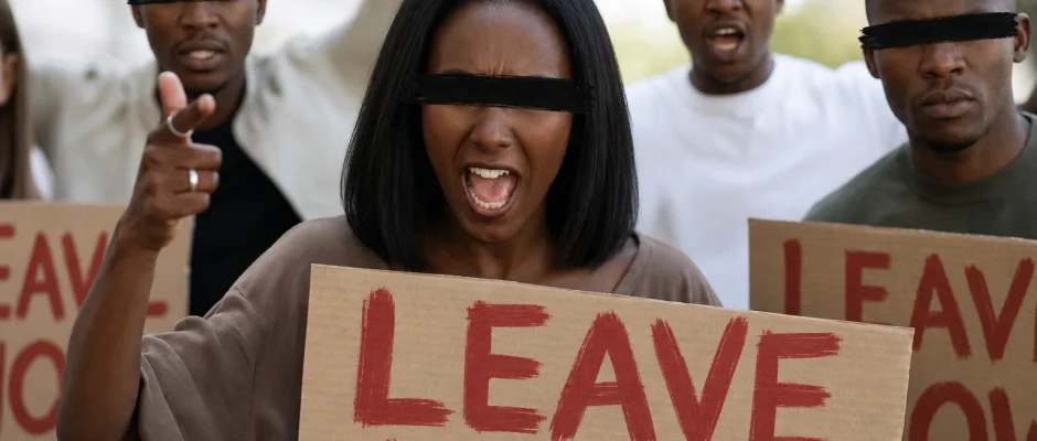 Protesters holding signs during unrest linked to xenophobic attacks in South Africa (simulated image)