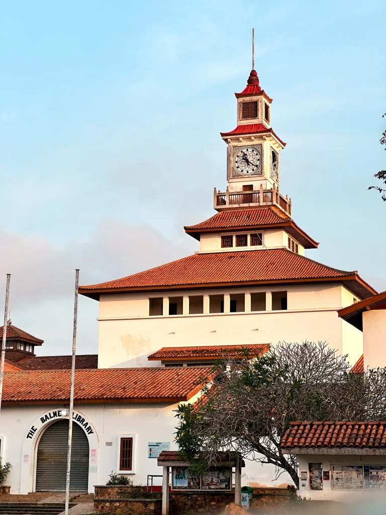 The iconic Balme Library Clock Tower at the University of Ghana, Accra, under a clear sky.